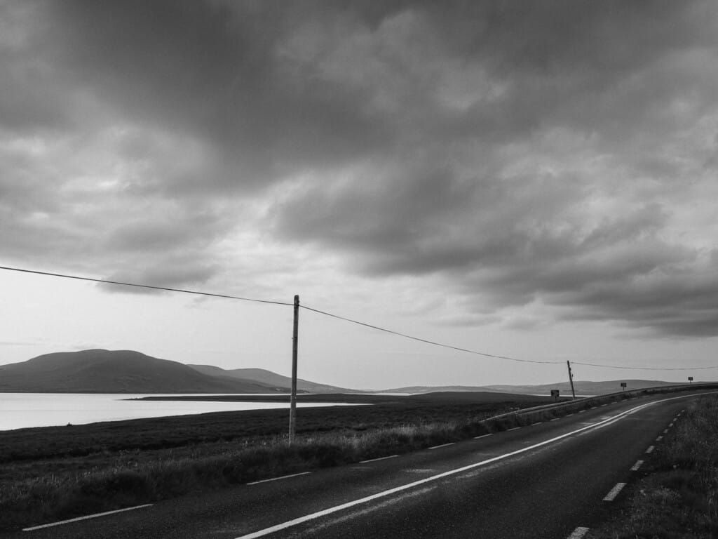 Empty Asphalt Country Road Leading To Dramatic Cloudy Sky